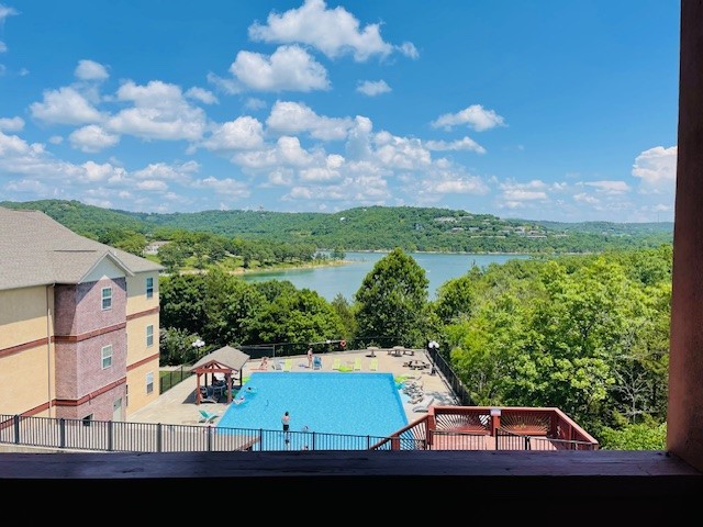 a view of a pool from an apartment balcony