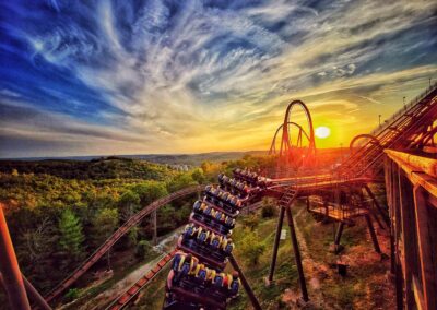 a roller coaster at an amusement park during sunset