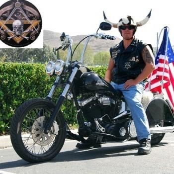 a man sitting on a motorcycle with an american flag