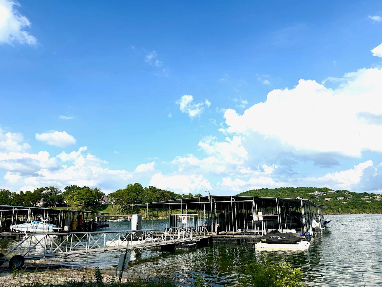 a boat dock on a lake with several boats