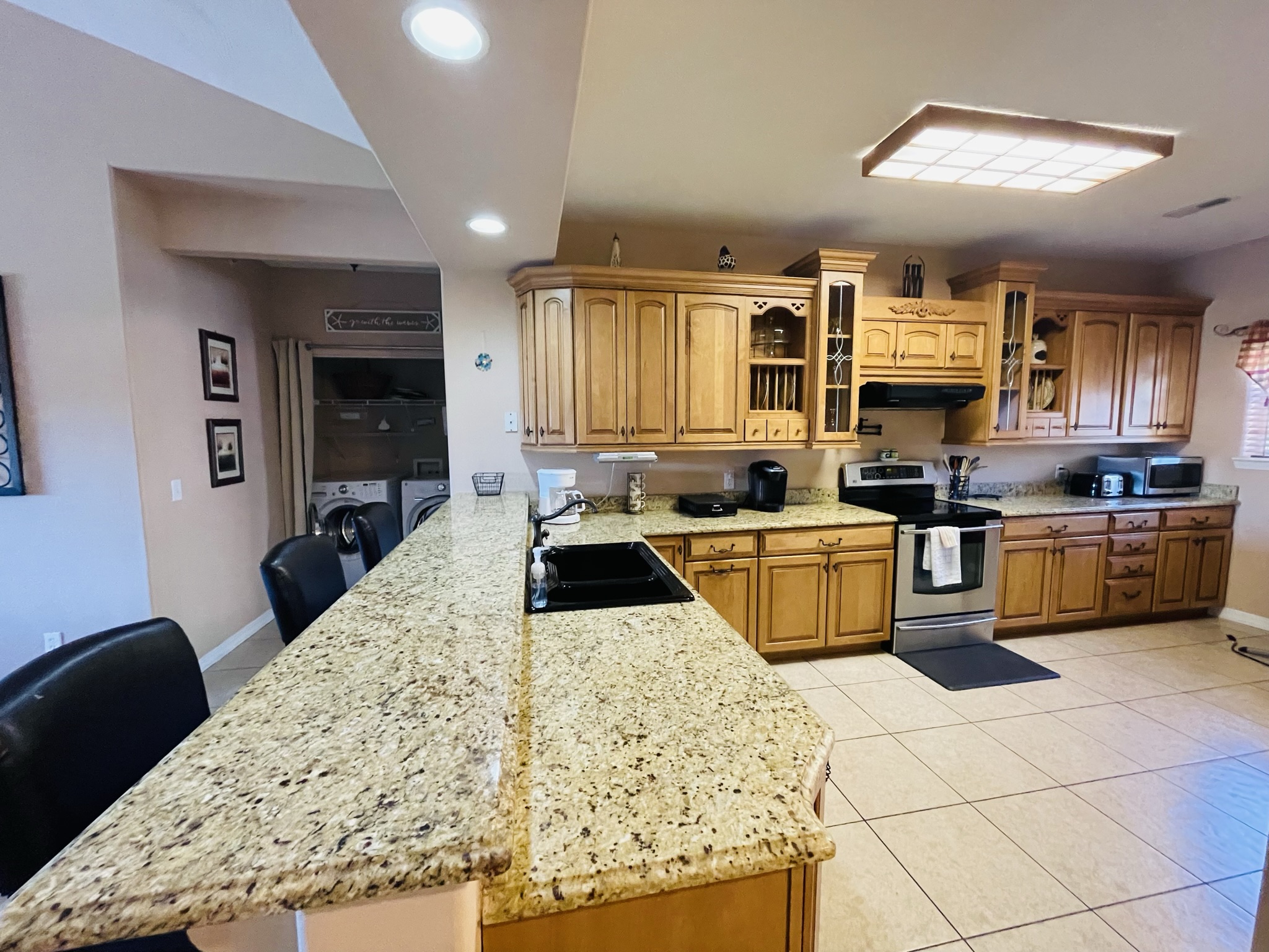 a large kitchen with a center island in the middle of the room