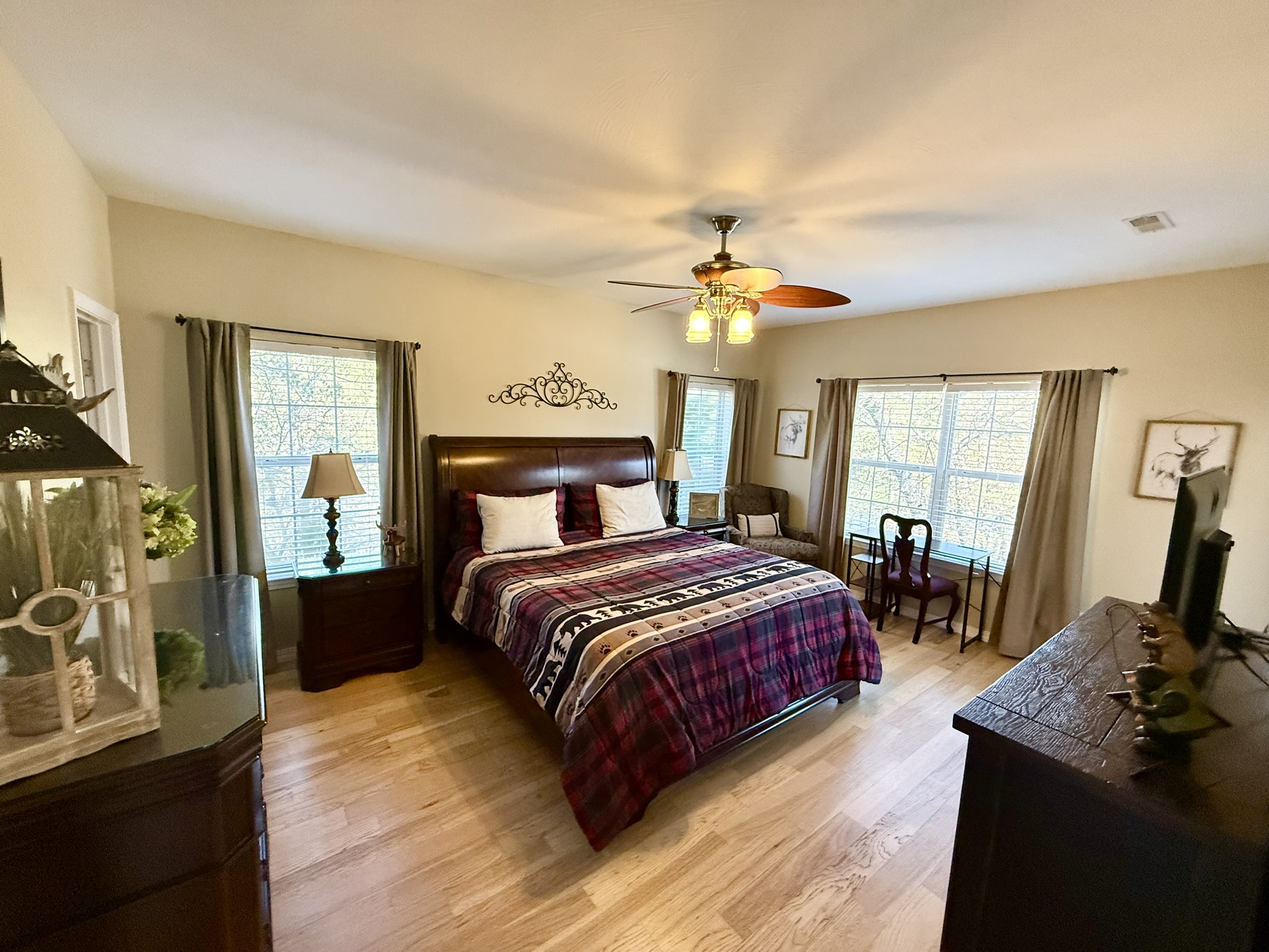 a bedroom with hardwood floors and a bed