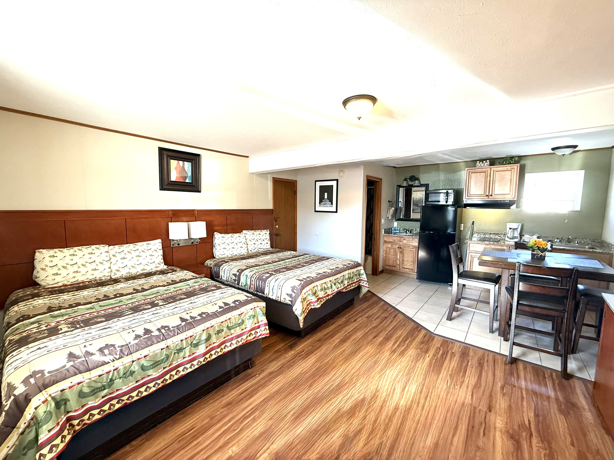 a hotel room with two beds and a kitchen