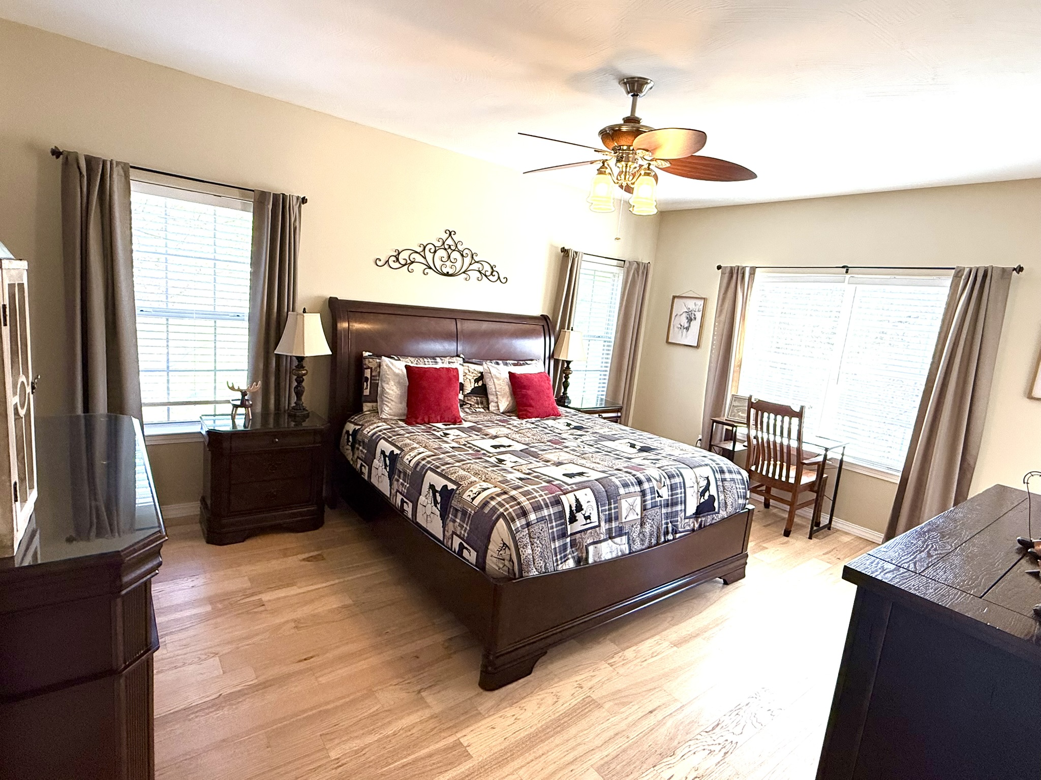 a bed room with a neatly made bed and a flat screen tv