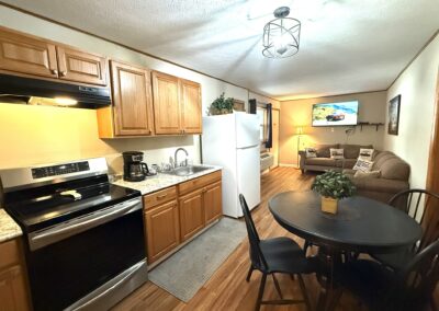 a kitchen with a table and chairs and a refrigerator