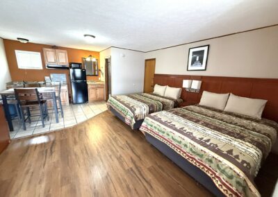 a hotel room with two beds and a kitchen