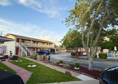 a street view of a motel with cars parked in front of it