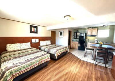 a hotel room with two beds and a kitchen